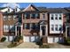 Charming brick townhome with black shutters, a one-car garage, and steps up to the front door at 2507 Princewood St, Raleigh, NC 27612