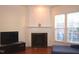 Living room fireplace with stone surround, white trim, and hardwood floors at 2507 Princewood St, Raleigh, NC 27612