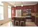 Bright kitchen with stainless steel appliances, granite countertops, and an island with seating at 2507 Princewood St, Raleigh, NC 27612