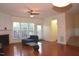 Open living room with hardwood floors, a ceiling fan, fireplace, and access to the back patio at 2507 Princewood St, Raleigh, NC 27612