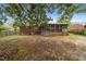 A partially shaded backyard with a screened porch offers outdoor living space at 2512 Mckinney St, Burlington, NC 27217