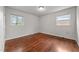 Bedroom with hardwood floors, neutral walls, and dual windows at 2512 Mckinney St, Burlington, NC 27217
