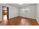 View of sunlit bedroom with hardwood floors and a spacious closet at 2512 Mckinney St, Burlington, NC 27217