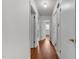 Hallway with natural wood flooring and access to all rooms at 2512 Mckinney St, Burlington, NC 27217