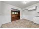 Eat-in kitchen features neutral cabinets and flows into an adjoining wood-paneled room at 2512 Mckinney St, Burlington, NC 27217