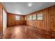Unique living room with knotty wood paneling and hardwood floors, perfect for a cozy, rustic ambiance at 2512 Mckinney St, Burlington, NC 27217