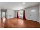 Bright living room featuring hardwood floors, a large window, and fresh paint, creating an inviting atmosphere at 2512 Mckinney St, Burlington, NC 27217