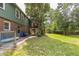 Spacious backyard with mature trees and a cozy deck area for outdoor entertaining at 2712 Pebblebrook Dr, Sanford, NC 27330