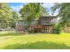 Spacious yard featuring a screened in porch and room for outdoor activities, bordered by a chain link fence at 2712 Pebblebrook Dr, Sanford, NC 27330