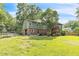 Spacious yard featuring a screened in porch and room for outdoor activities, bordered by a chain link fence at 2712 Pebblebrook Dr, Sanford, NC 27330