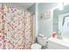 This bathroom has a floral shower curtain and pastel blue walls at 2712 Pebblebrook Dr, Sanford, NC 27330