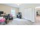 Bright bedroom with closet and window, featuring neutral colors and ample space for a home office at 2712 Pebblebrook Dr, Sanford, NC 27330