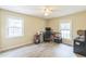 This empty room has two large windows and a desk at 2712 Pebblebrook Dr, Sanford, NC 27330