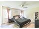 Comfortable main bedroom with a ceiling fan, cozy carpet, and soft natural light from windows at 2712 Pebblebrook Dr, Sanford, NC 27330