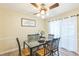 Cozy dining room featuring a glass-top table, a ceiling fan, and natural light from nearby windows at 2712 Pebblebrook Dr, Sanford, NC 27330