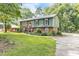 A charming two story home with a mix of brick and green wood and a well maintained front lawn at 2712 Pebblebrook Dr, Sanford, NC 27330