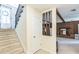 Bright foyer featuring a staircase with carpeted steps, and a view into the living space with a fireplace at 2712 Pebblebrook Dr, Sanford, NC 27330