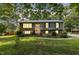 Charming two-story home features a well-maintained lawn and classic brick and siding facade at 2712 Pebblebrook Dr, Sanford, NC 27330