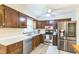 Updated kitchen with stainless steel appliances, wood cabinetry, and ample counter space for cooking at 2712 Pebblebrook Dr, Sanford, NC 27330