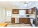 Charming kitchen featuring wooden cabinets, stainless steel appliances, and a bright window above the sink at 2712 Pebblebrook Dr, Sanford, NC 27330