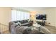 Comfortable living room featuring a large sectional sofa, a flat-screen TV, and lots of natural light at 2712 Pebblebrook Dr, Sanford, NC 27330