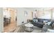 Living room with a view into the dining area and featuring a plush gray sectional sofa and modern decor at 2712 Pebblebrook Dr, Sanford, NC 27330