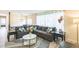 Inviting living room featuring a gray sectional, stylish rug, and large window for natural light at 2712 Pebblebrook Dr, Sanford, NC 27330