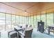 Inviting screened porch with comfortable seating, an outdoor grill, and a view of the surrounding greenery at 2712 Pebblebrook Dr, Sanford, NC 27330
