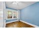 This bedroom features natural light from the windows, hardwood floors, a built-in bookshelf, and a ceiling fan at 2715 E Geer St, Durham, NC 27704