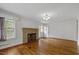 Inviting living room with brick fireplace and hardwood floors at 2715 E Geer St, Durham, NC 27704