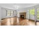 Bright living room featuring hardwood floors, fireplace, and natural light at 2715 E Geer St, Durham, NC 27704