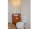 A bathroom featuring a toilet and a sink with a mirror at 305 Wallington Ct, Mebane, NC 27302