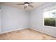 Bright bedroom featuring neutral carpet, ceiling fan and a sunlit window with leafy outdoor views at 305 Wallington Ct, Mebane, NC 27302
