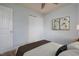 Digitally staged bedroom showcases neutral decor, a ceiling fan, and bright natural light from the window at 305 Wallington Ct, Mebane, NC 27302