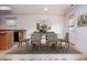 A bright dining room with a dining table set with chairs and views of the backyard through the window at 305 Wallington Ct, Mebane, NC 27302