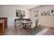 A bright dining room with a dining table set with chairs and views of the backyard through the window at 305 Wallington Ct, Mebane, NC 27302