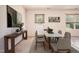 A bright dining room with a dining table set with chairs and views of the backyard through the window at 305 Wallington Ct, Mebane, NC 27302