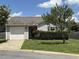 Charming single Gathering home featuring lush green lawn, mature landscaping, and an attached one car garage at 305 Wallington Ct, Mebane, NC 27302