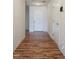 Bright hallway with wood floors and a white door, creating a welcoming entrance to the home at 305 Wallington Ct, Mebane, NC 27302