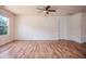 Large, bright room featuring a ceiling fan, wood floors, and an inviting atmosphere at 305 Wallington Ct, Mebane, NC 27302