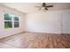 Spacious room with wood floors and a ceiling fan, bathed in natural light from the window at 305 Wallington Ct, Mebane, NC 27302