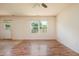 An empty living room featuring beautiful wood floors, a ceiling fan, and ample natural light at 305 Wallington Ct, Mebane, NC 27302