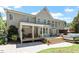 Expansive backyard featuring covered porch, hot tub, outdoor seating, and mature landscaping at 312 Flint Point Ln, Holly Springs, NC 27540