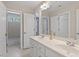 Bathroom featuring double sink vanity with white cabinets, neutral walls, and tile flooring at 312 Flint Point Ln, Holly Springs, NC 27540