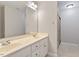 Bright bathroom featuring a double sink vanity, large mirror, and walk-in shower, offering functionality and style at 312 Flint Point Ln, Holly Springs, NC 27540