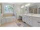 Spa-like bathroom with double vanity, soaking tub, and neutral color palette at 312 Flint Point Ln, Holly Springs, NC 27540
