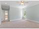 Spacious bedroom with neutral carpet, large window, and ensuite bathroom at 312 Flint Point Ln, Holly Springs, NC 27540