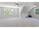 Bonus room boasts bright neutral paint, large carpeted area, windows and an airy feeling, great for activities at 312 Flint Point Ln, Holly Springs, NC 27540