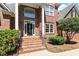 Close up of the brick house's front entrance, showcasing landscaping, windows, and architectural details at 312 Flint Point Ln, Holly Springs, NC 27540