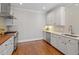 Well-lit kitchen featuring stainless steel appliances, white cabinets, and wood countertops at 312 Flint Point Ln, Holly Springs, NC 27540